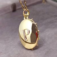 Pingente Relicário em Ouro 18k 750 com Bolinhas e 2 Letras com Diamantes