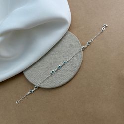 PULSEIRA COM 7 ZIRCÔNIAS REDONDAS AZUIS CLARA COM ... - C Martiniano Joias