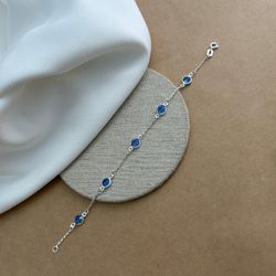 PULSEIRA COM 5 ZIRCÔNIAS REDONDAS AZUIS ESCURO CAR... - C Martiniano Joias