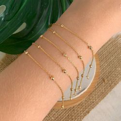 Pulseira de bolinhas delicadas (cada) - P3025 - Lojas das Revendedoras