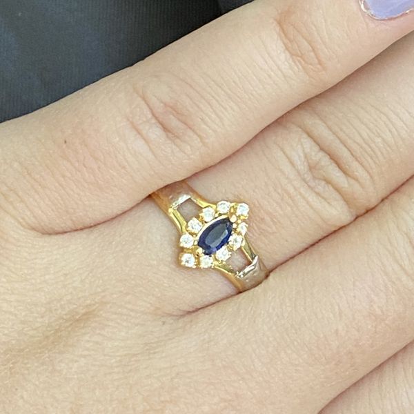 Anel de formatura em ouro 18 k com 3.1 gramas com oito pedras de zircônia com uma navete em safira sintética com dois símbolos em ouro branco 
