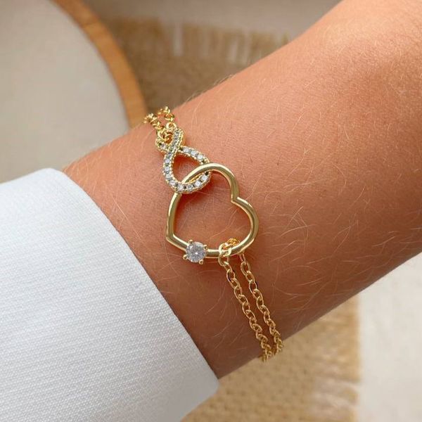 Pulseira infinito cravejado com coração liso e vazado 